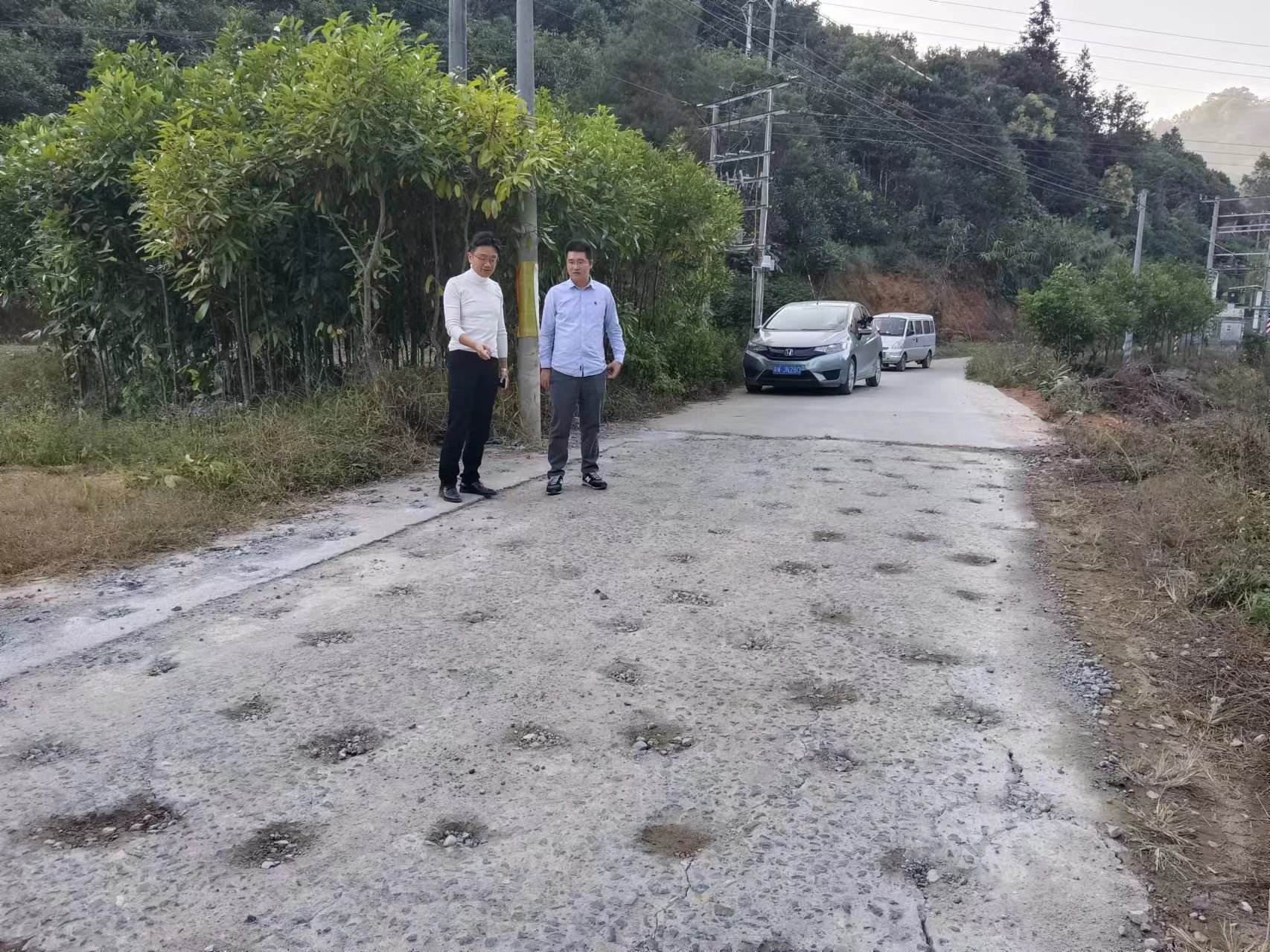 梅波（右一）和鎮(zhèn)領導到現場視察道路修復情況。  鐘梅 攝.jpg